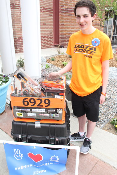 Miles Gregg, a 17-year-old from Highlands Ranch, stands along a walkway of robots built by Colorado robotics teams at a May 15 memorial service for Kendrick Castillo, a local robotics team member who was killed in the May 7 shooting at STEM School Highlands Ranch. Gregg’s team includes two STEM School students, he said.